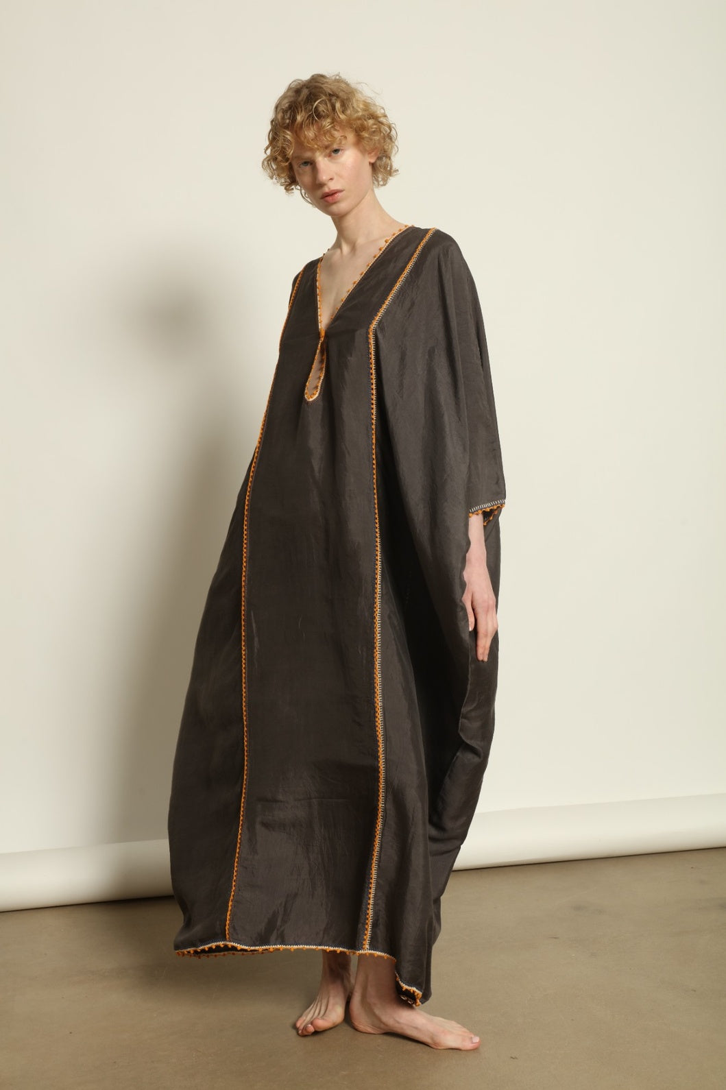 Model is wearing the Thea Grey Silk Dress by Supernaturae x HONS, crafted in handwoven silk from Murshidabad, featuring a relaxed flowing silhouette, elegant open back and natural hand-dyed grey tones. Part of the House of Woven Stories selection