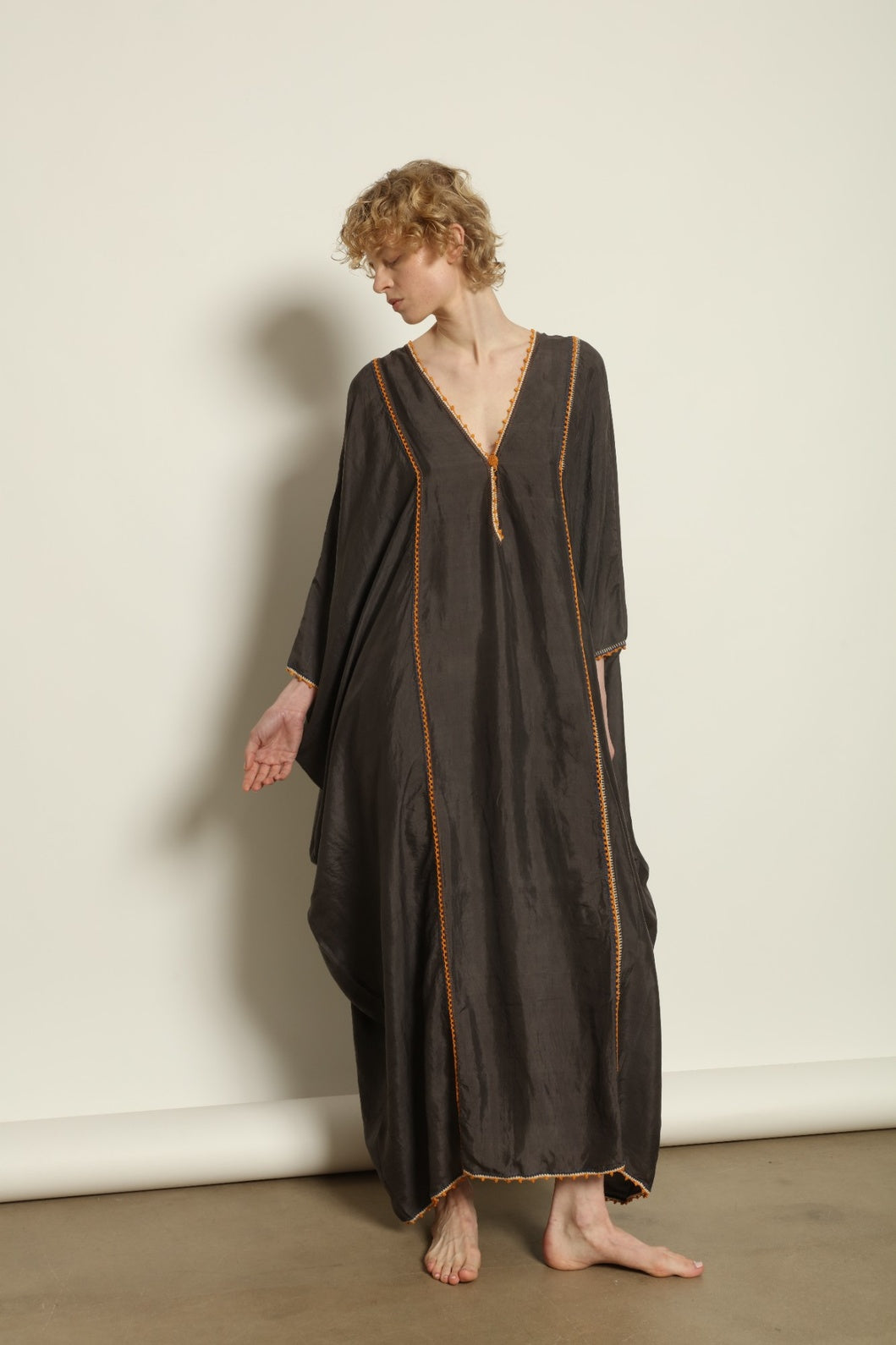 Model is wearing the Thea Grey Silk Dress by Supernaturae x HONS, crafted in handwoven silk from Murshidabad, featuring a relaxed flowing silhouette, elegant open back and natural hand-dyed grey tones. Part of the House of Woven Stories selection
