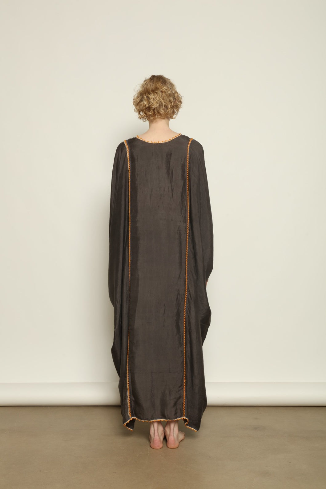 Model is wearing the Thea Grey Silk Dress by Supernaturae x HONS, crafted in handwoven silk from Murshidabad, featuring a relaxed flowing silhouette, elegant open back and natural hand-dyed grey tones. Part of the House of Woven Stories selection