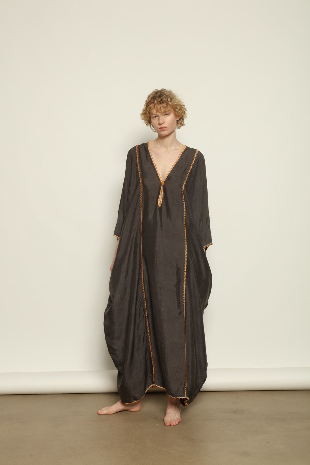 Model is wearing the Thea Grey Silk Dress by Supernaturae x HONS, crafted in handwoven silk from Murshidabad, featuring a relaxed flowing silhouette, elegant open back and natural hand-dyed grey tones. Part of the House of Woven Stories selection