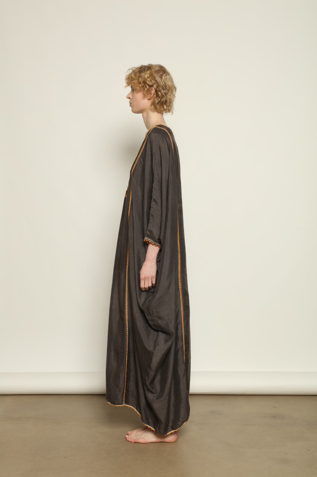 Model is wearing the Thea Grey Silk Dress by Supernaturae x HONS, crafted in handwoven silk from Murshidabad, featuring a relaxed flowing silhouette, elegant open back and natural hand-dyed grey tones. Part of the House of Woven Stories selection