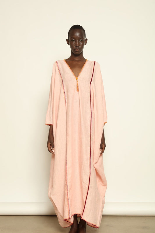 Model is wearing the Thea Pink Linen Dress by Supernaturae x HONS in soft botanical hibiscus pink linen, featuring a relaxed oversized silhouette, open back detail and breathable sustainable fabric. Part of the House of Woven Stories curated selection.