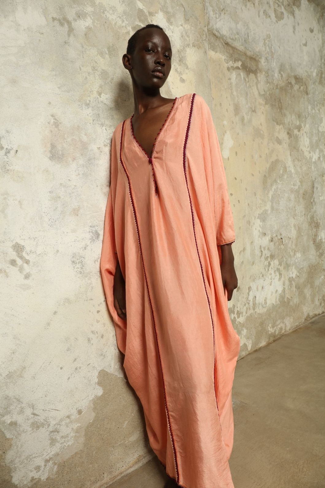 Model is wearing the Thea Rose Silk Dress by Supernaturae x HONS, crafted in handwoven silk from Murshidabad with a soft botanical rose dye finish, featuring a relaxed flowing silhouette and deep open back design. Part of the House of Woven Stories selection, this sustainable slow luxury piece reflects ethical artisan craftsmanship and natural dye variations.