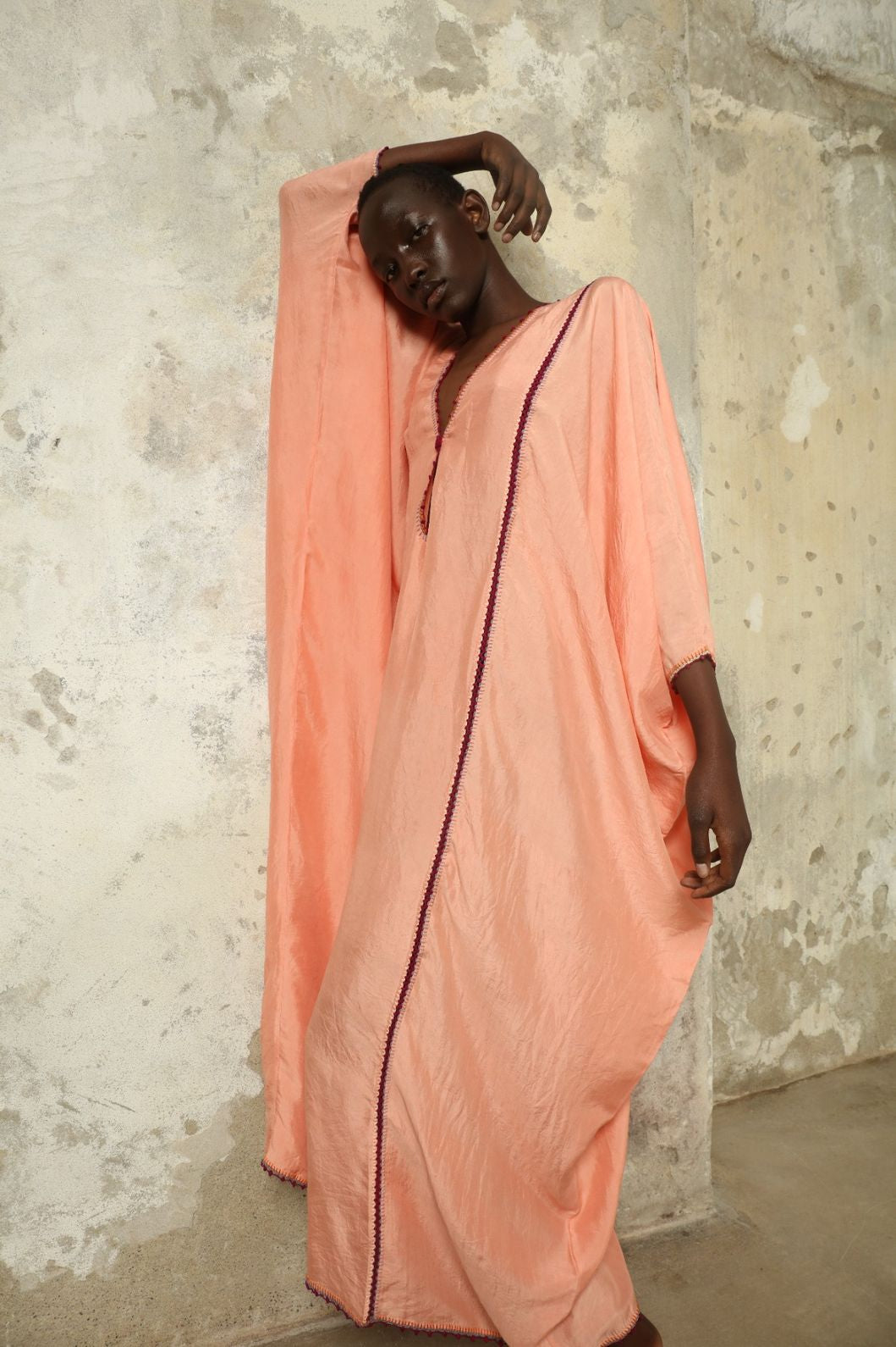 Model is wearing the Thea Rose Silk Dress by Supernaturae x HONS, crafted in handwoven silk from Murshidabad with a soft botanical rose dye finish, featuring a relaxed flowing silhouette and deep open back design. Part of the House of Woven Stories selection, this sustainable slow luxury piece reflects ethical artisan craftsmanship and natural dye variations.