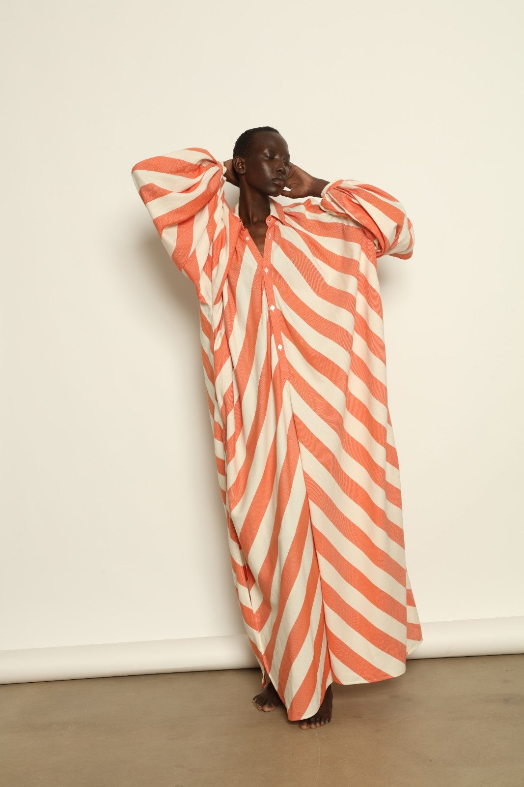 Model is wearing The Touareg Dress with Balloon Sleeve by Marrakshi Life, part of House of Nomad Stories collection, handwoven artisanal cotton dress with sweeping silhouette and dramatic balloon sleeves