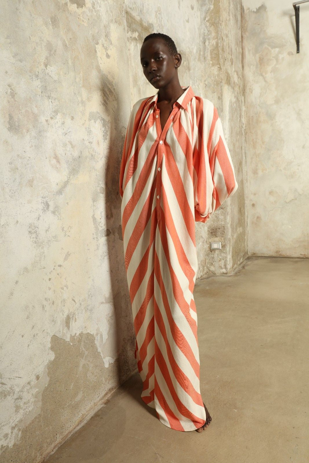 Model is wearing The Touareg Dress with Balloon Sleeve by Marrakshi Life, part of House of Nomad Stories collection, handwoven artisanal cotton dress with sweeping silhouette and dramatic balloon sleeves