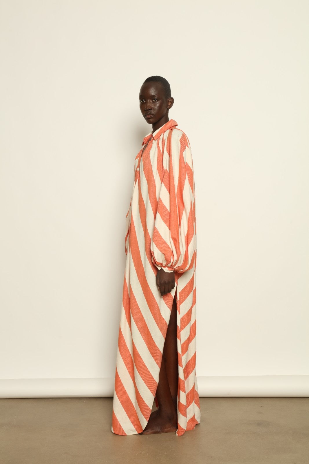 Model is wearing The Touareg Dress with Balloon Sleeve by Marrakshi Life, part of House of Nomad Stories collection, handwoven artisanal cotton dress with sweeping silhouette and dramatic balloon sleeves