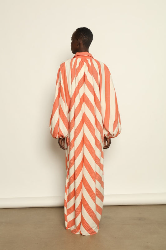 Model is wearing The Touareg Dress with Balloon Sleeve by Marrakshi Life, part of House of Nomad Stories collection, handwoven artisanal cotton dress with sweeping silhouette and dramatic balloon sleeves