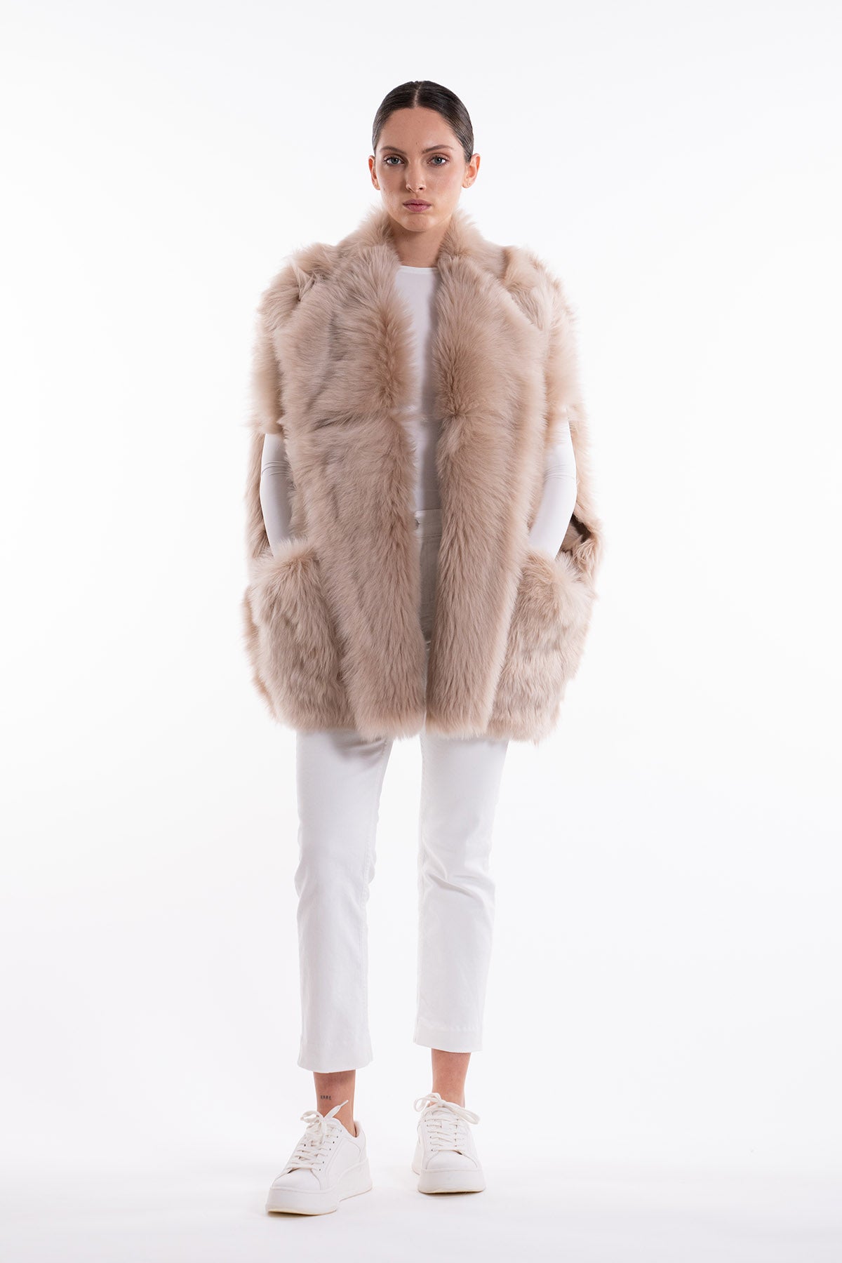 Model is wearing the Toscana Sabbia Shearling Vest by Blancha, made from 100% Toscana sheepskin in a soft Sabbia shade, showcasing warmth, fluid drape, and versatile layering. Part of House of Woven Stories selection.