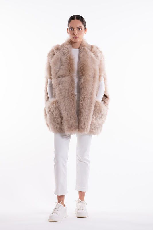 Model is wearing the Toscana Sabbia Shearling Vest by Blancha, made from 100% Toscana sheepskin in a soft Sabbia shade, showcasing warmth, fluid drape, and versatile layering. Part of House of Woven Stories selection.