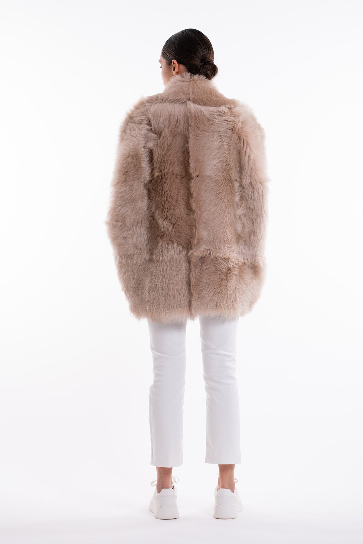 Model is wearing the Toscana Sabbia Shearling Vest by Blancha, made from 100% Toscana sheepskin in a soft Sabbia shade, showcasing warmth, fluid drape, and versatile layering. Part of House of Woven Stories selection.