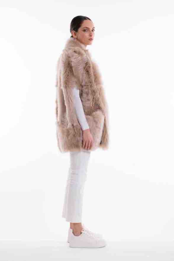 Model is wearing the Toscana Sabbia Shearling Vest by Blancha, made from 100% Toscana sheepskin in a soft Sabbia shade, showcasing warmth, fluid drape, and versatile layering. Part of House of Woven Stories selection.