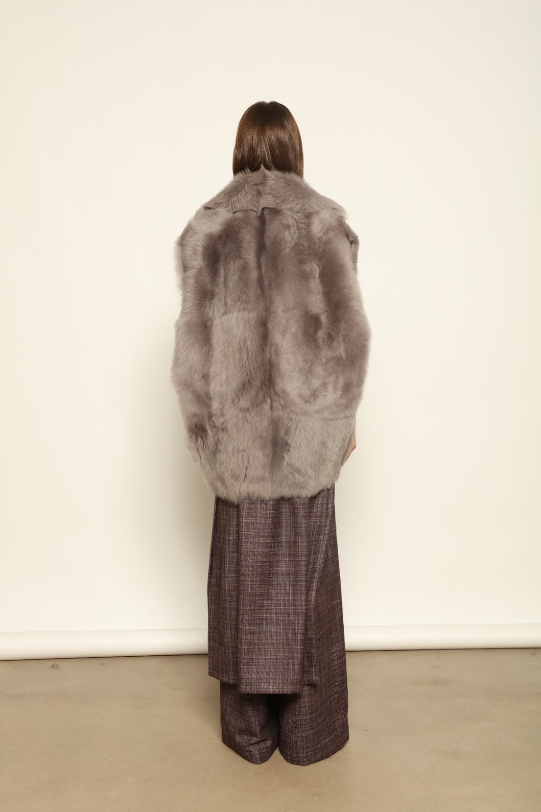 Model is wearing the Toscana Storm Shearling Vest by Blancha, crafted from 100% Toscana sheepskin in the Storm shade with soft, luxurious texture and Italian craftsmanship.