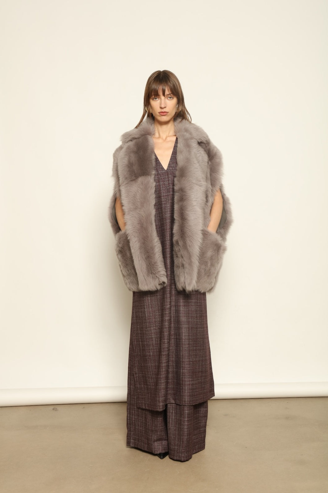 Model is wearing the Toscana Storm Shearling Vest by Blancha, crafted from 100% Toscana sheepskin in the Storm shade with soft, luxurious texture and Italian craftsmanship.