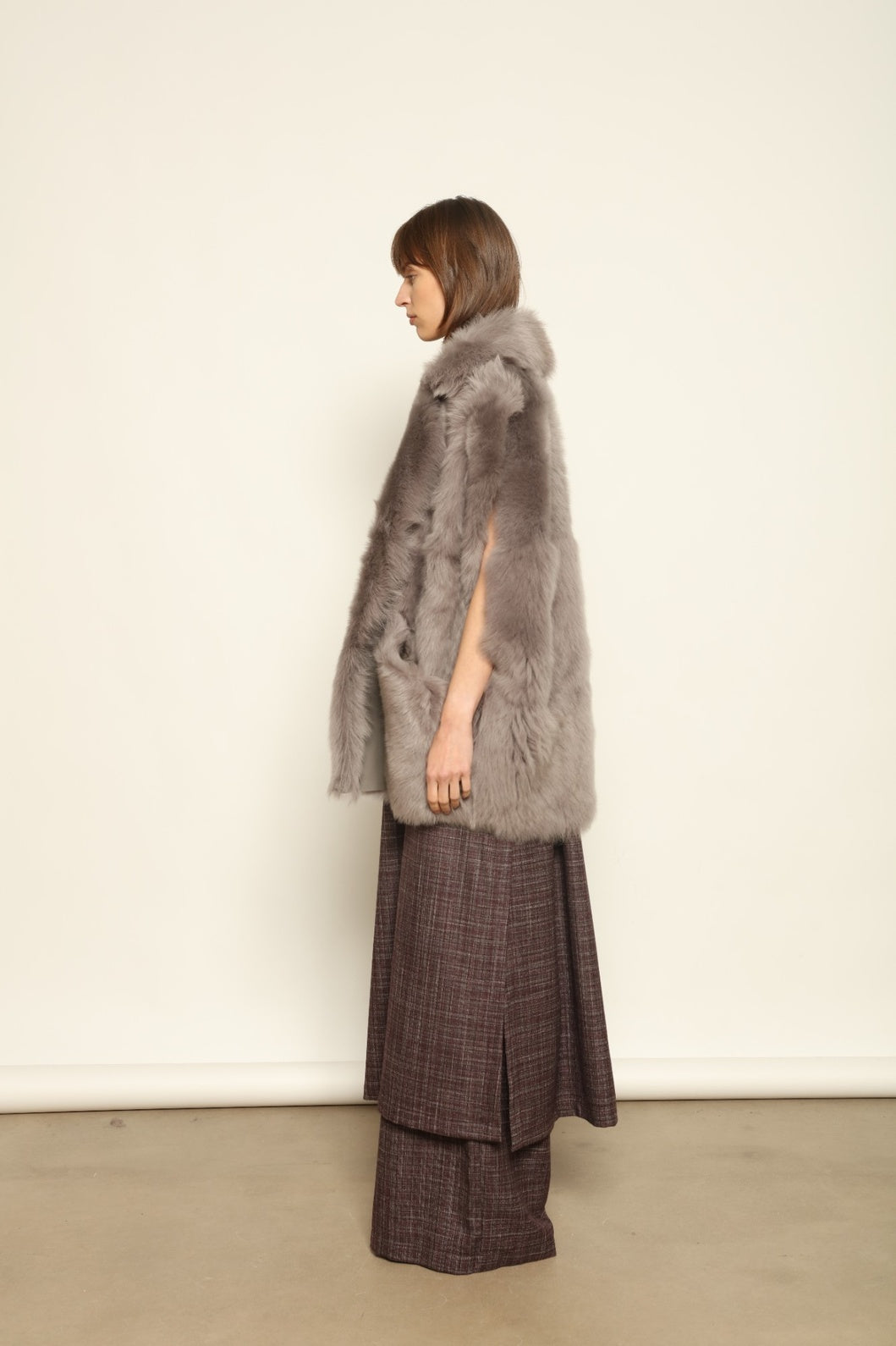 Model is wearing the Toscana Storm Shearling Vest by Blancha, crafted from 100% Toscana sheepskin in the Storm shade with soft, luxurious texture and Italian craftsmanship.