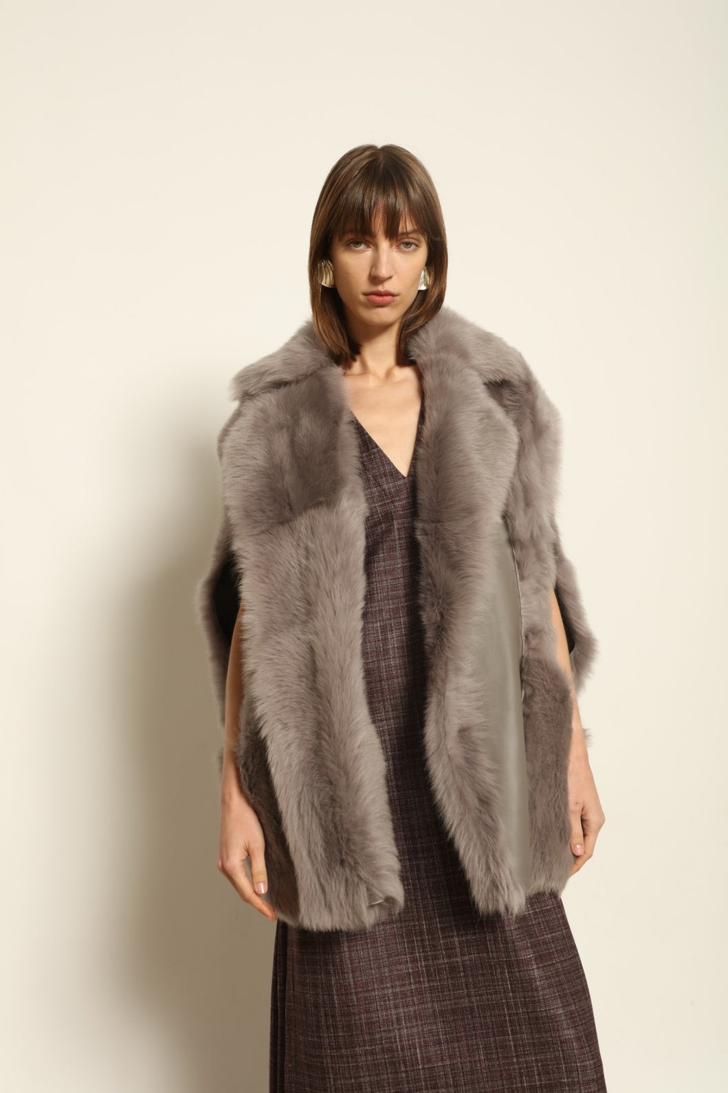 Model is wearing the Toscana Storm Shearling Vest by Blancha, crafted from 100% Toscana sheepskin in the Storm shade with soft, luxurious texture and Italian craftsmanship.