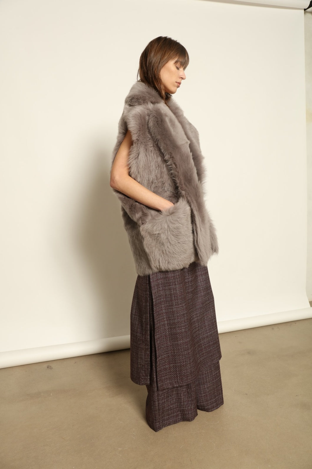 Model is wearing the Toscana Storm Shearling Vest by Blancha, crafted from 100% Toscana sheepskin in the Storm shade with soft, luxurious texture and Italian craftsmanship.