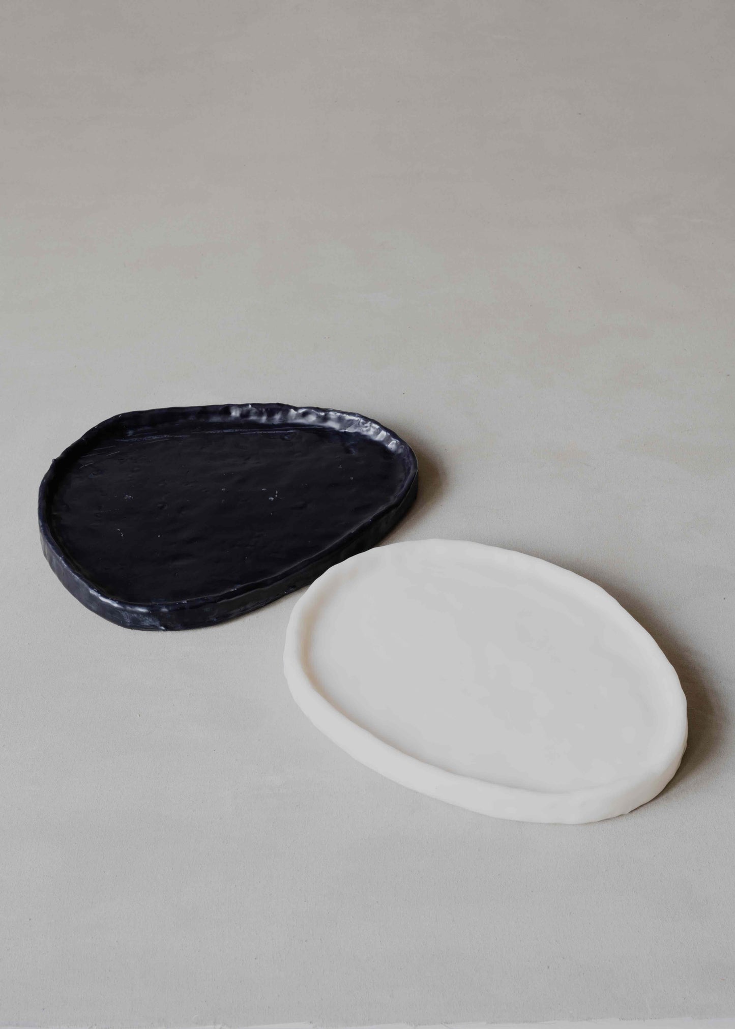 Tray Oval in Black by Oberflacht, part of the House of Woven Stories selection, handcrafted from beeswax and paraffin with smooth matte finish and unique variations in colour and texture.