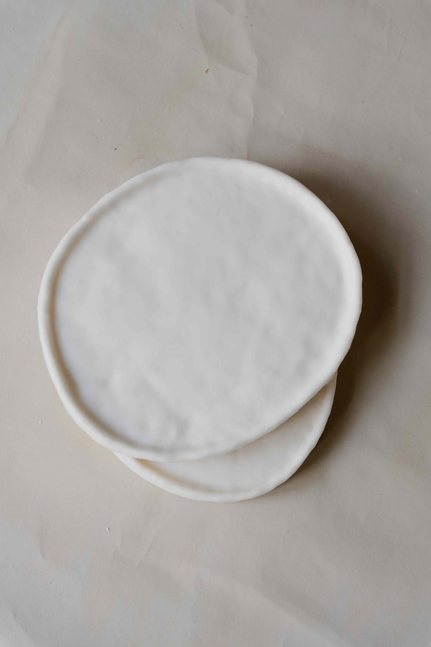 Tray Oval in Cream by Oberflacht, part of the House of Woven Stories selection, handcrafted from beeswax and paraffin with smooth matte finish and unique natural variations.