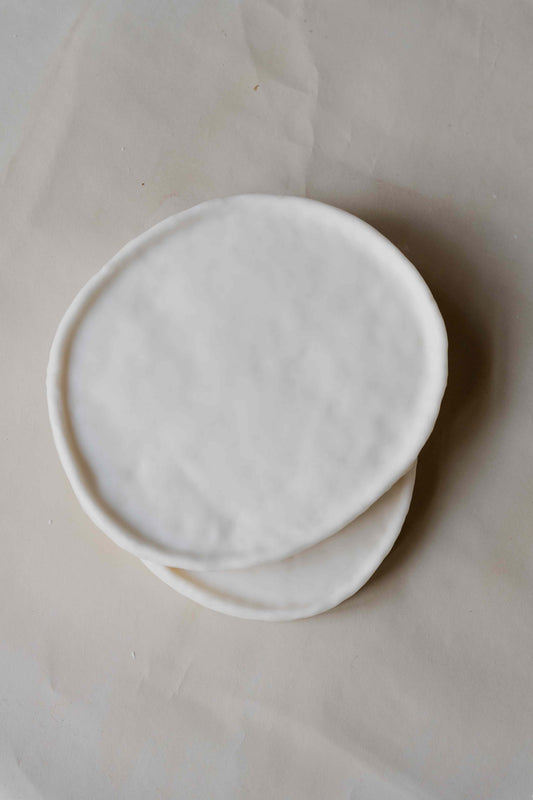 Tray Oval in Cream by Oberflacht, part of the House of Woven Stories selection, handcrafted from beeswax and paraffin with smooth matte finish and unique natural variations.