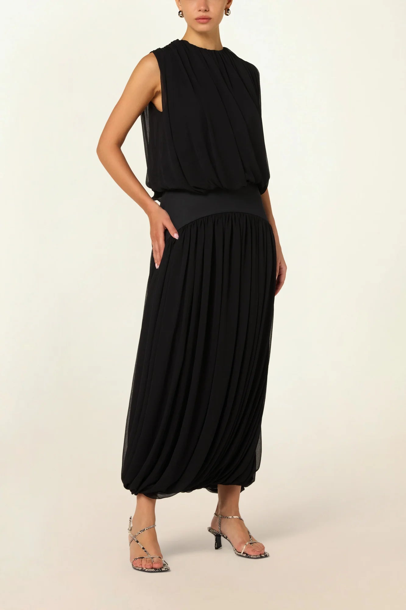 Model wearing a black Twisted Bubble Top by Abadia from the House of Nomad Stories collection, featuring sculptural volume, twisted front detail, and a bold yet refined silhouette.
