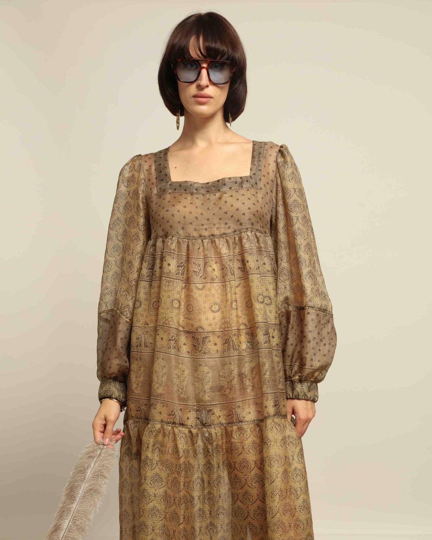 Model is wearing vintage-inspired maxi dress in lightweight 100% silk chiffon with square neckline, voluminous sleeves, and delicate all-over print. Part of House of Woven Stories selection.