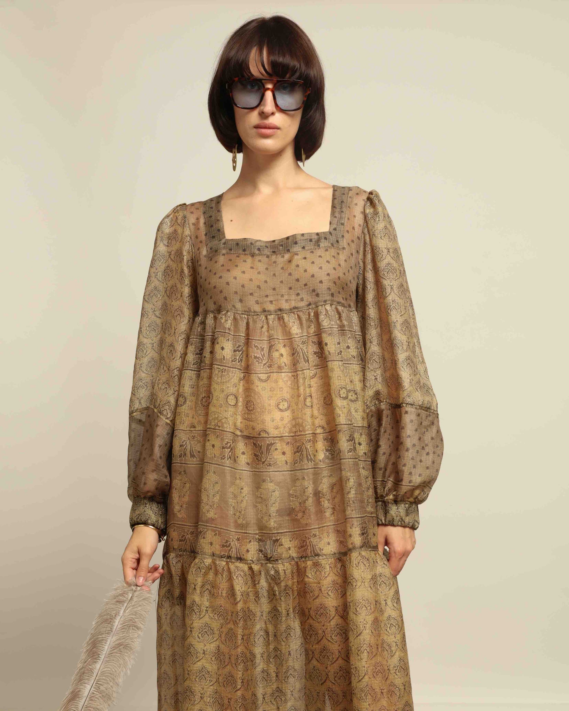 Model is wearing vintage-inspired maxi dress in lightweight 100% silk chiffon with square neckline, voluminous sleeves, and delicate all-over print. Part of House of Woven Stories selection.