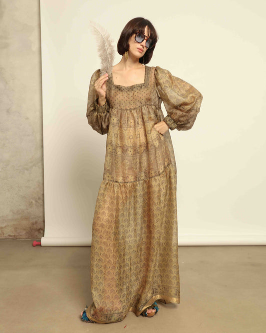 Model is wearing vintage-inspired maxi dress in lightweight 100% silk chiffon with square neckline, voluminous sleeves, and delicate all-over print. Part of House of Woven Stories selection.