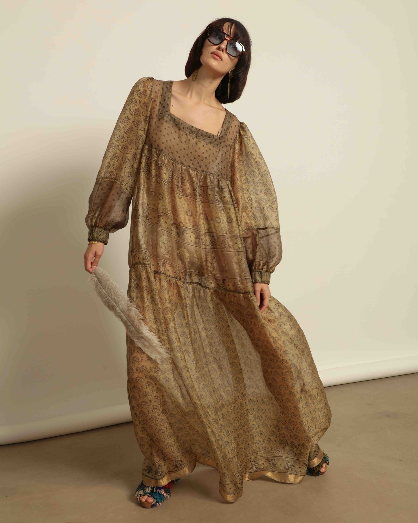 Model is wearing vintage-inspired maxi dress in lightweight 100% silk chiffon with square neckline, voluminous sleeves, and delicate all-over print. Part of House of Woven Stories selection.